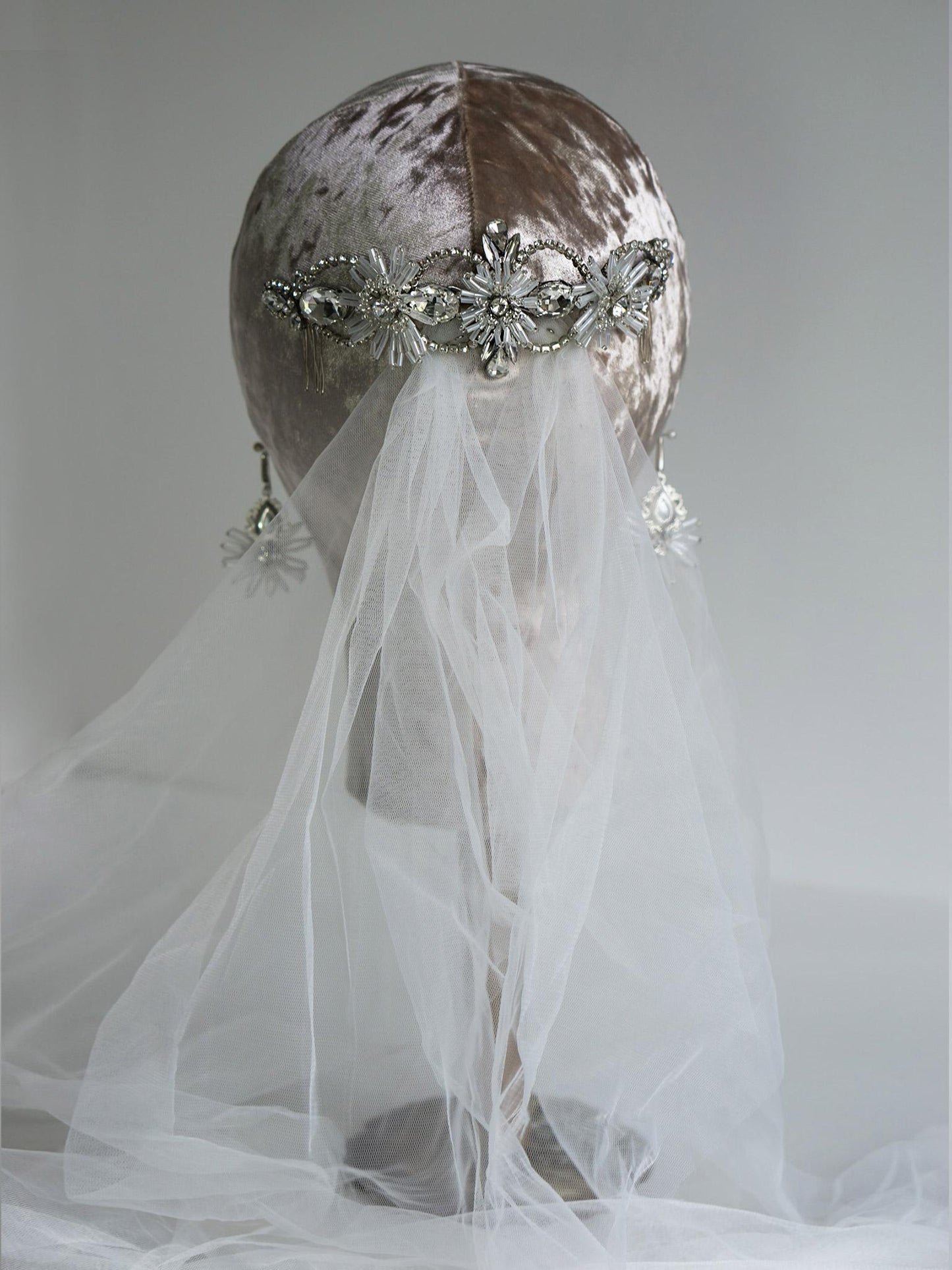 Elegant bridal hair accessory featuring sparkling silver rhinestones and crystal chains
