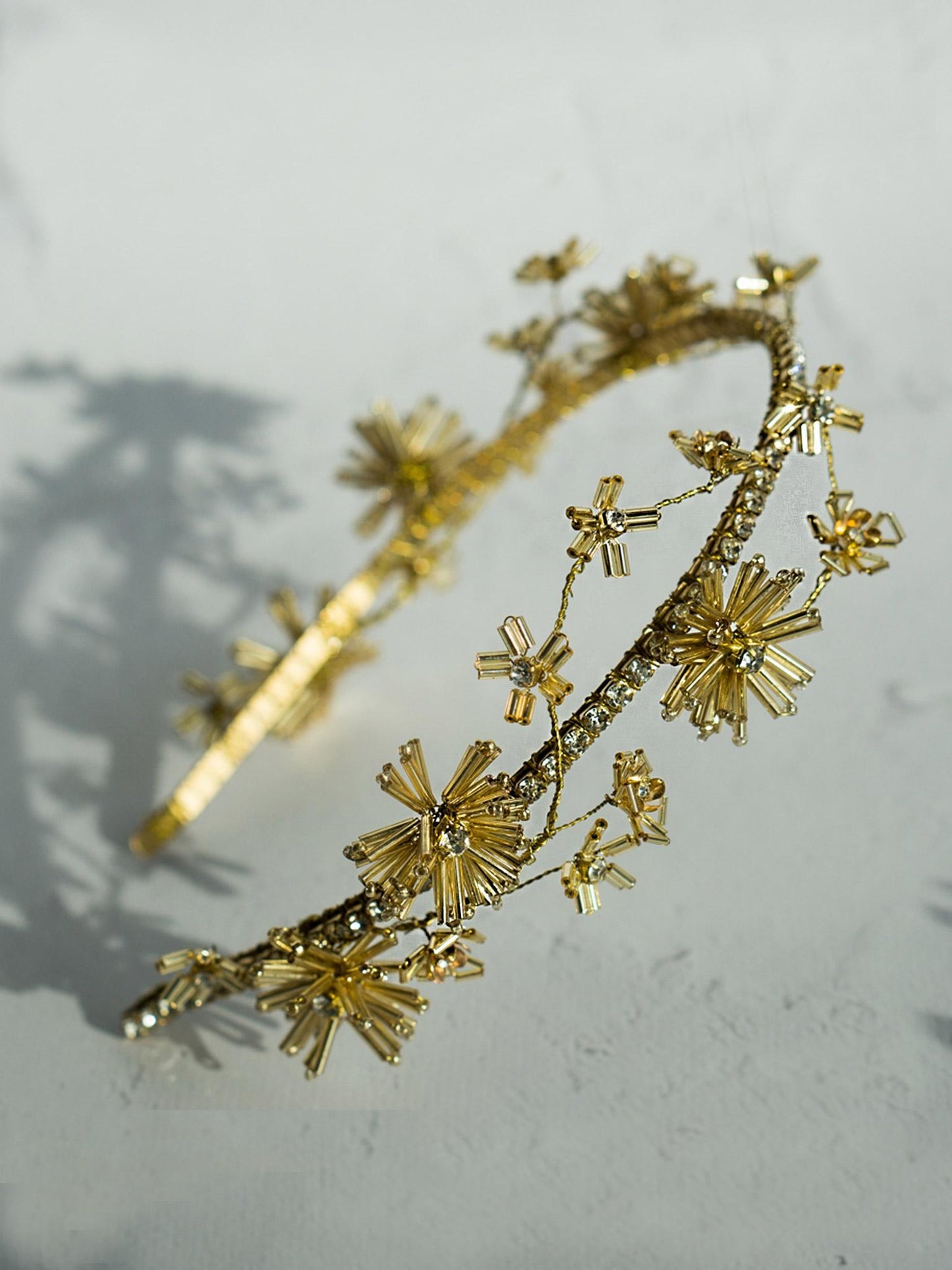 Gold bridal headband adorned with small wildflowers and crystal chain