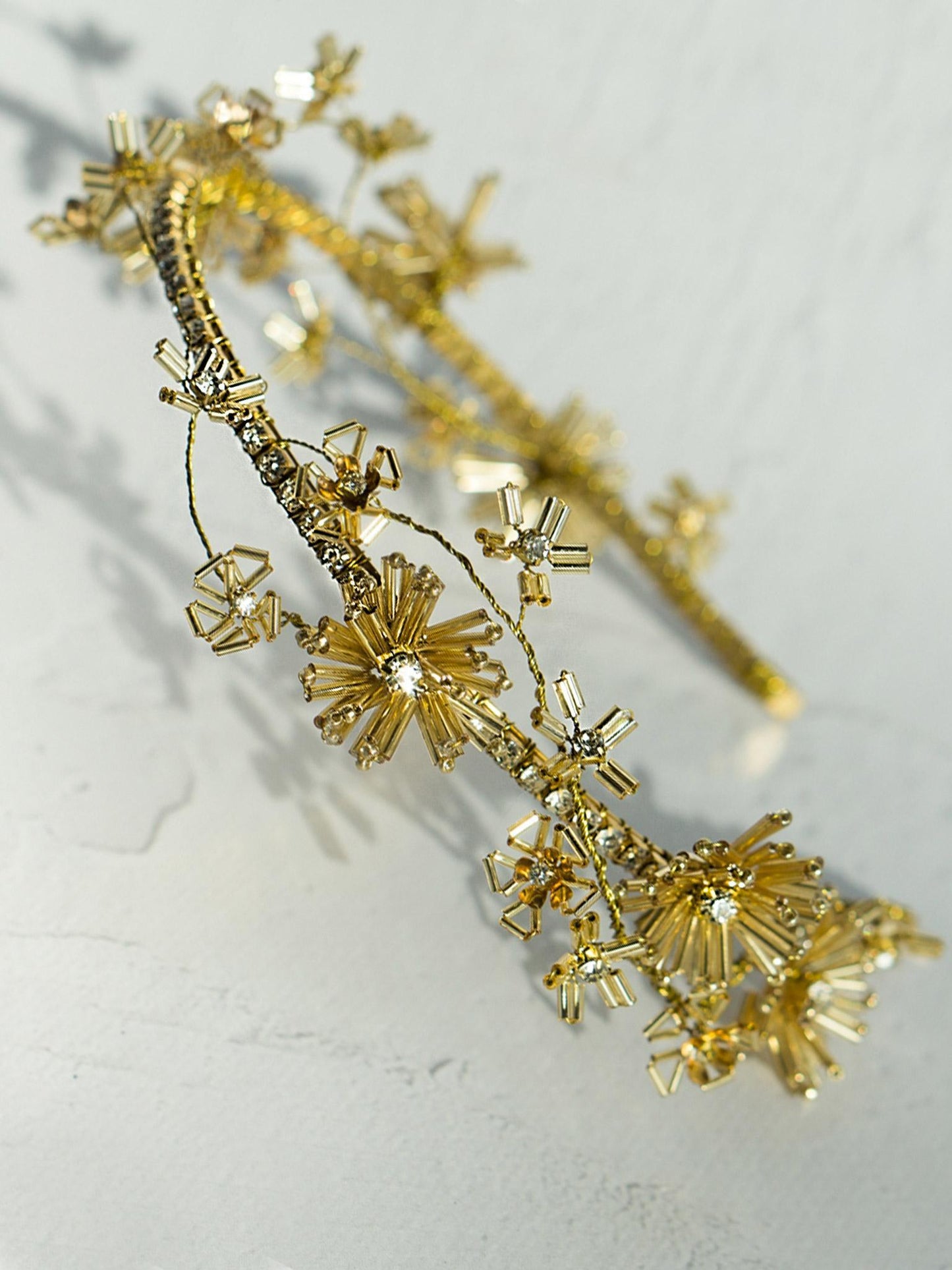 Elegant wedding hair piece with crystal chain and floral accents