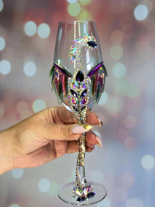 Glittering dragon-encrusted wineglass with multifaceted crystals capturing a dance of colorful city lights in the background