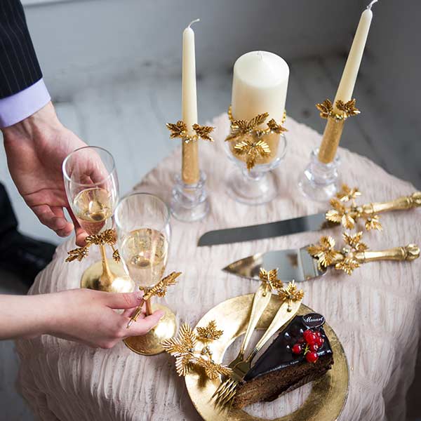 wedding design decor in one style - wedding candles, 2 toast glasses, cake knife and cake server, cake plate and 2 forks for the newlywed couple