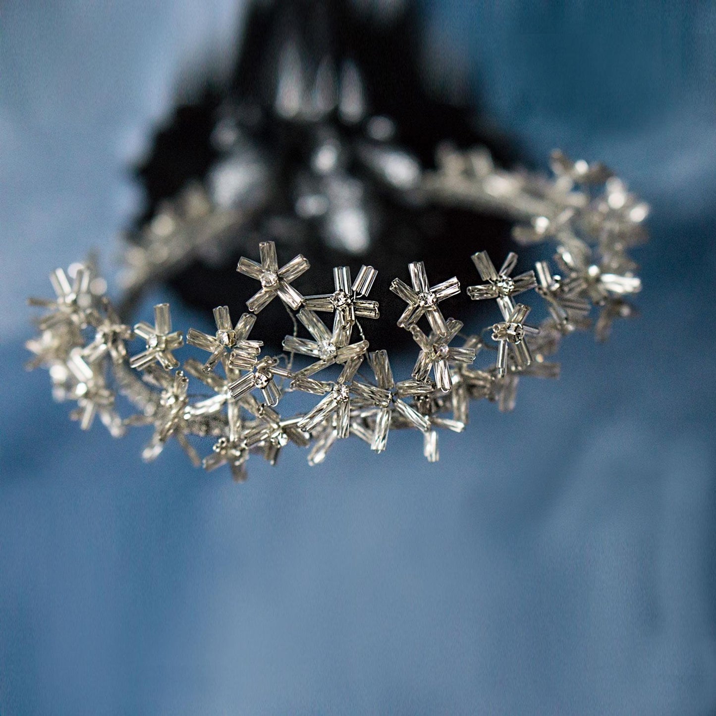 Close-up ofSilver Flower Daisy Tiara on blue background