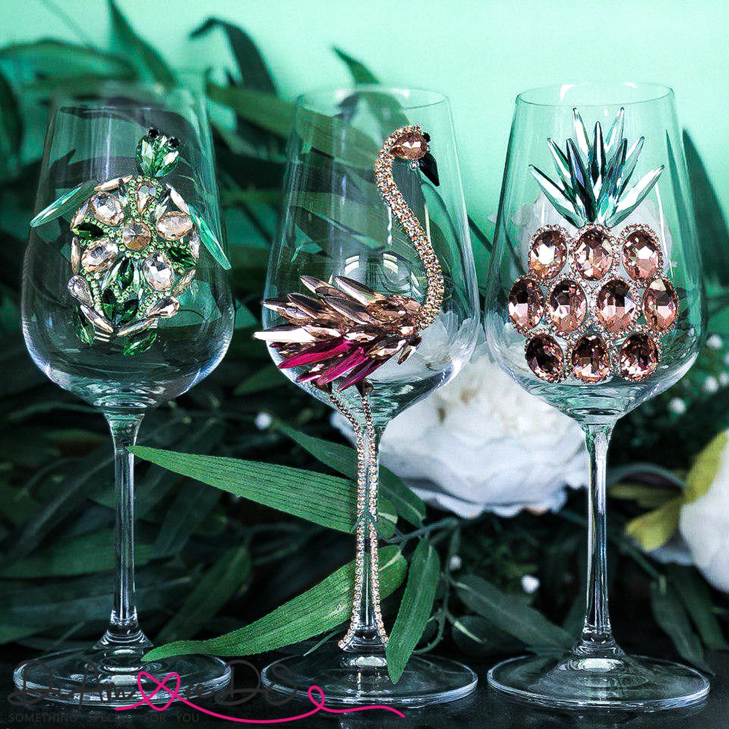 Luxury hand-decorated champagne glasses featuring crystal-studded pink flamingos and green sea turtles, ideal for sophisticated events.