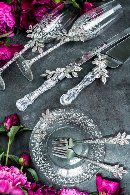 Silver-themed wedding champagne glasses and cake utensils