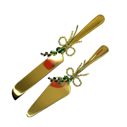 Gold cake knife and server set with garnet stones and shimmering crystals