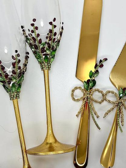 Wedding champagne flutes and gold cake servers in floral design