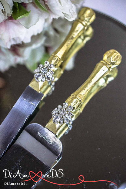 Elegant gold and silver cake knife and champagne flutes