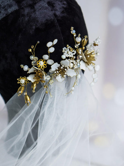 Gold hair pin with delicate white flowers and eucalyptus branches