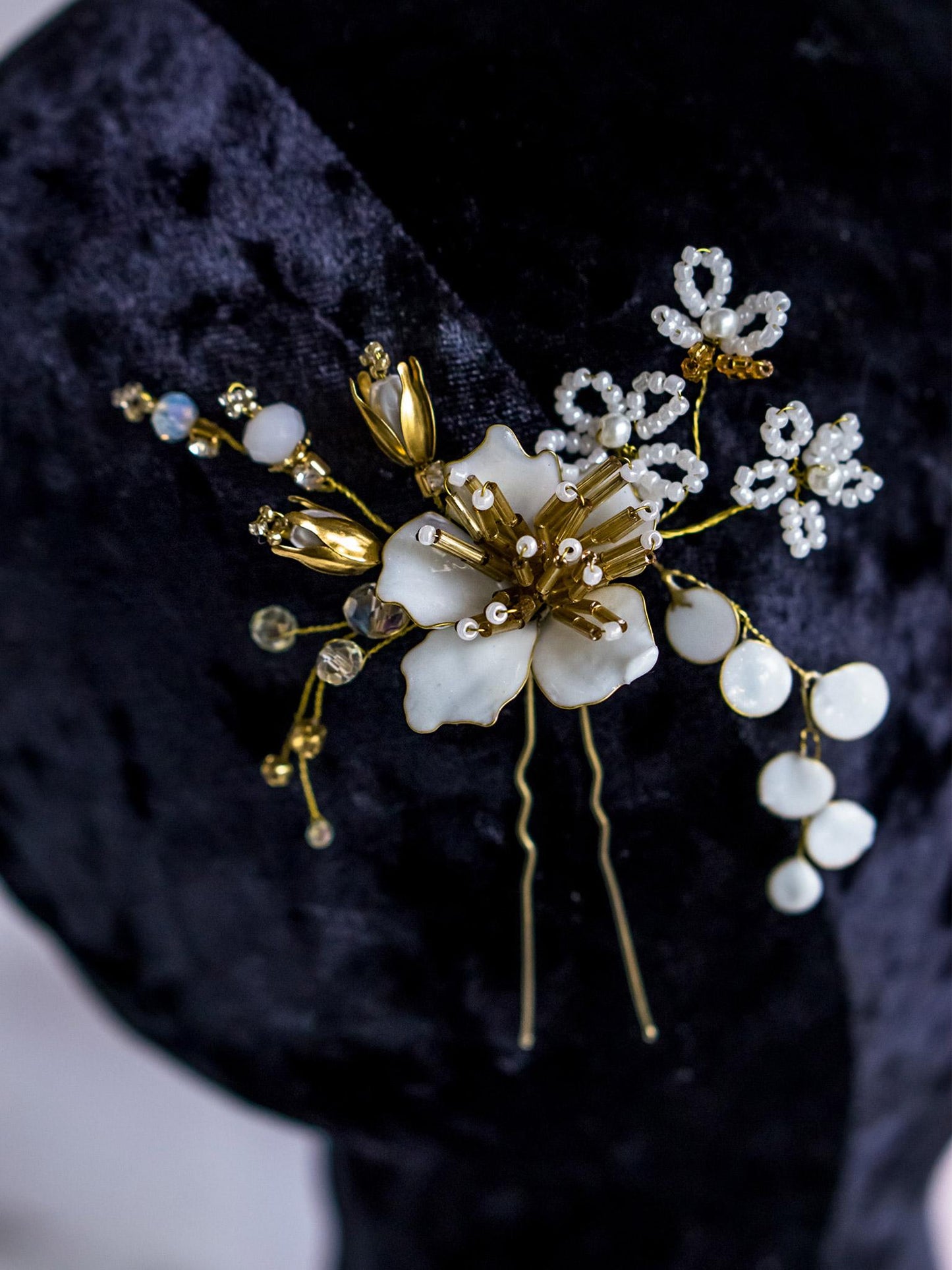 Close-up of gold hair pin with beaded flower center