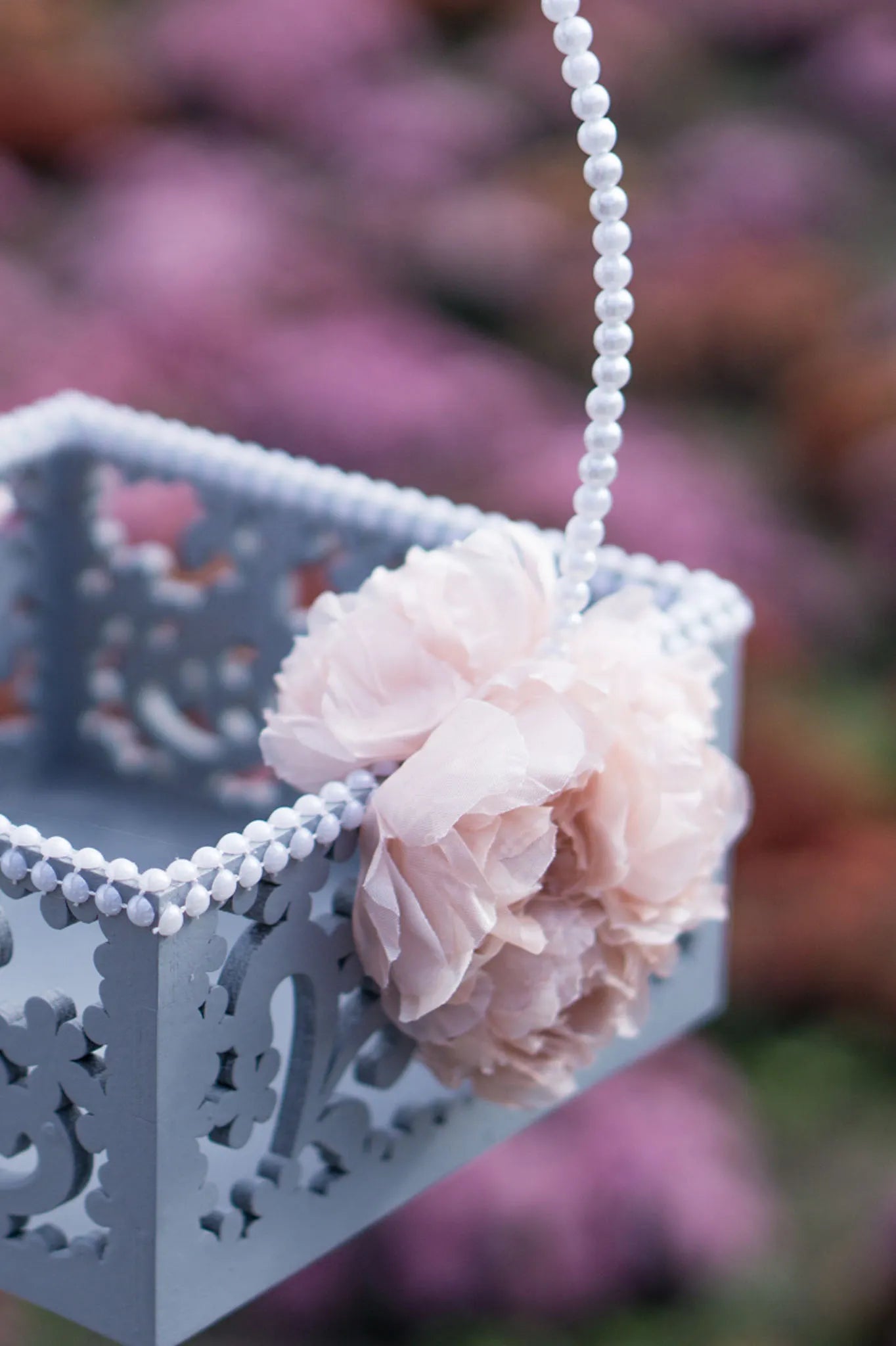 Handcrafted flower girl basket featuring delicate pearl details