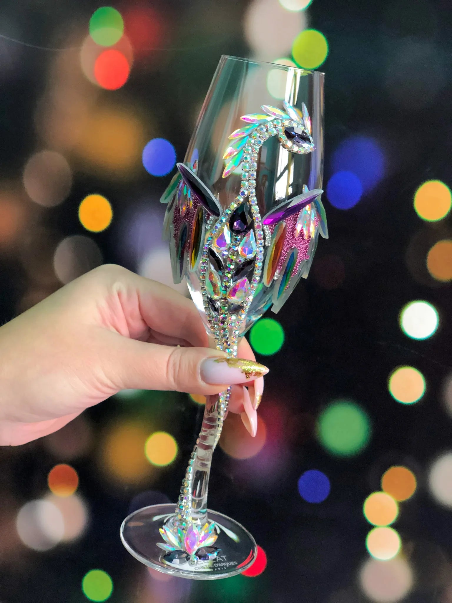 Dazzling dragon-themed stemware set against a backdrop of twinkling multi-colored lights, capturing the essence of mystical elegance.