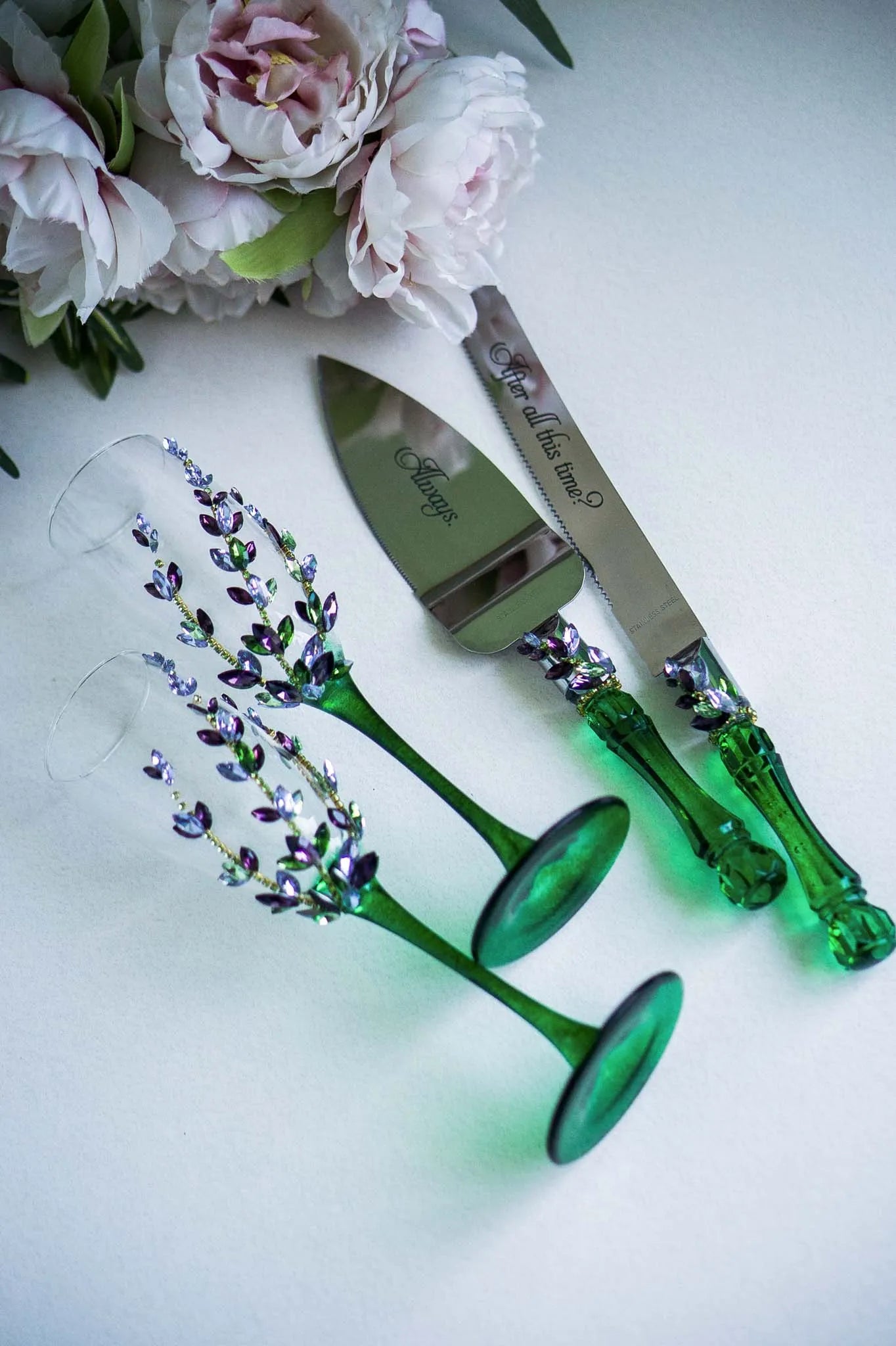 Crystal and wildflower-themed wedding flutes and cake utensils