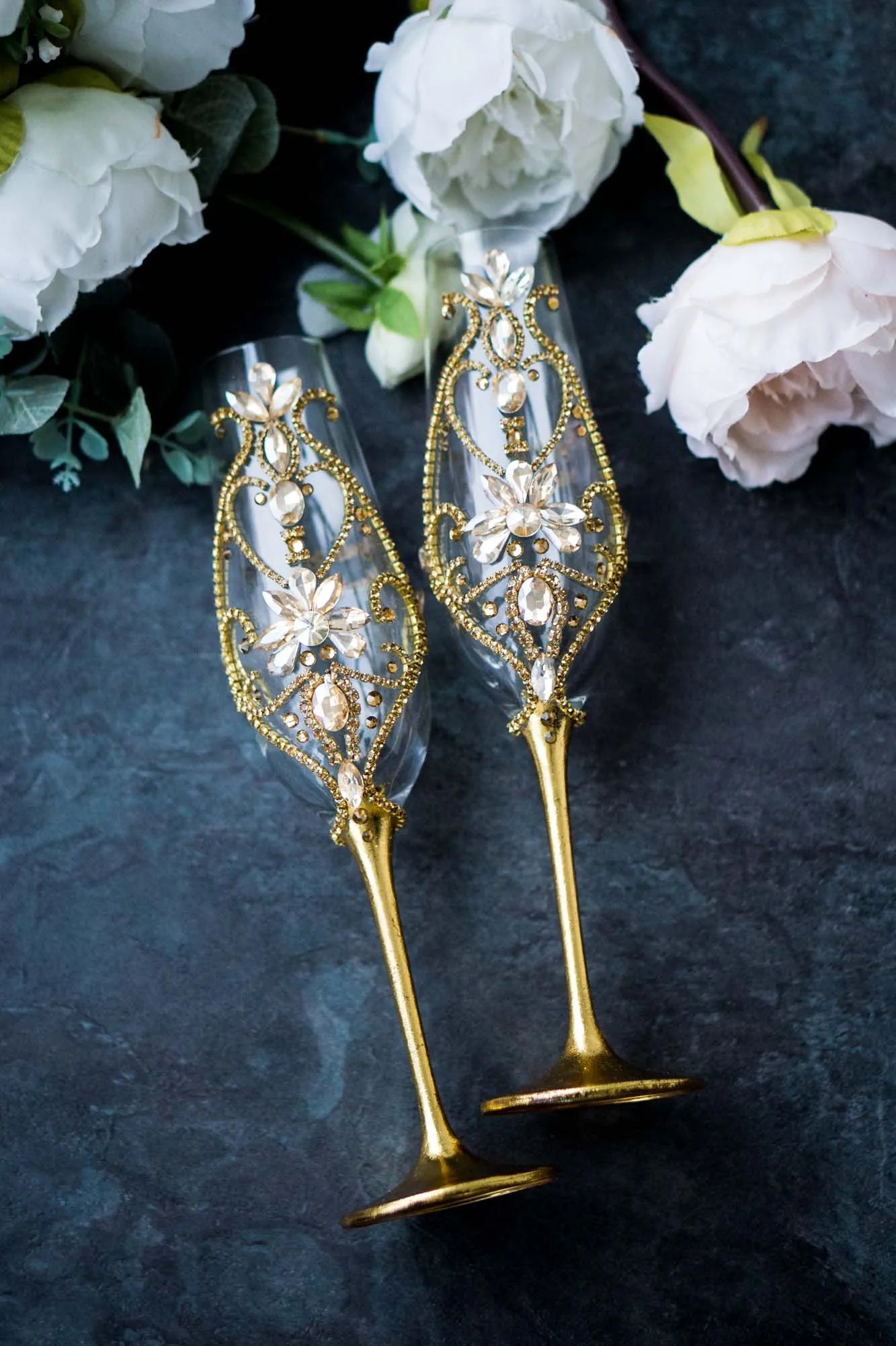 Elegant gold wedding toasting flutes with crystal accents