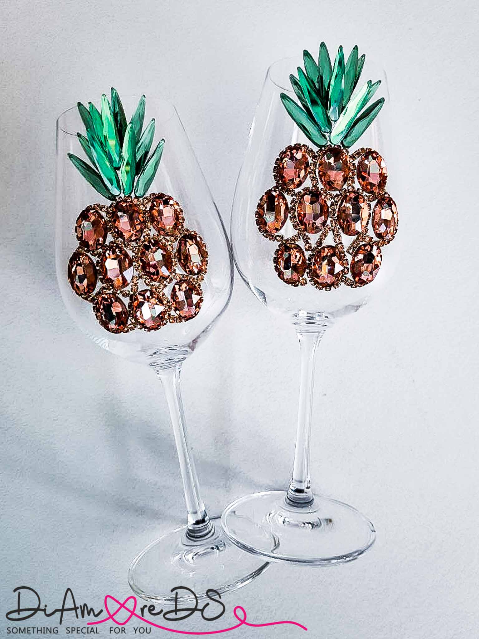 Luxury rose gold crystal pineapple motif on a clear wine glass, reflecting exquisite craftsmanship.