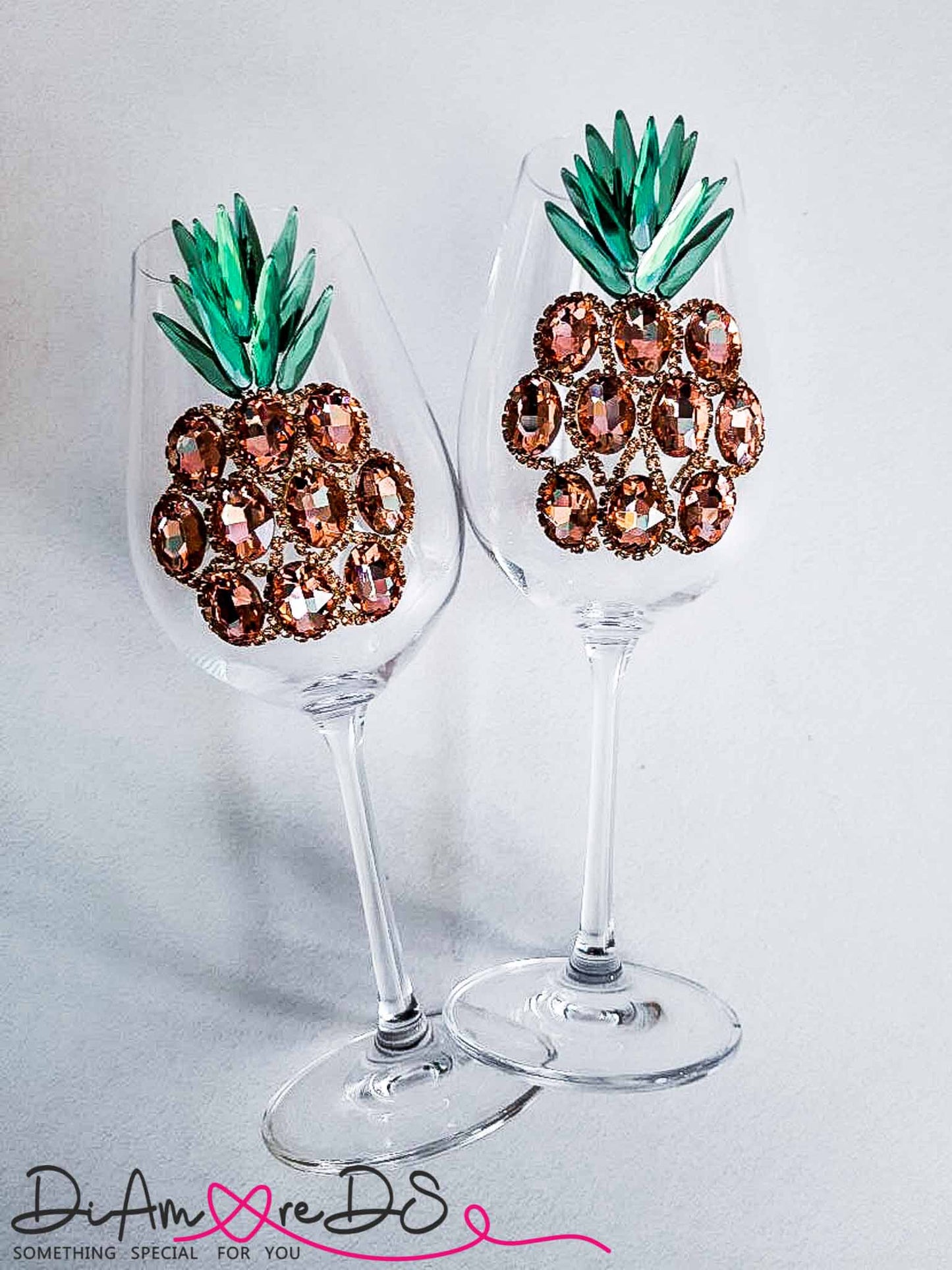 Handcrafted wine glass featuring a tropical rose gold pineapple design, perfect for chic table settings