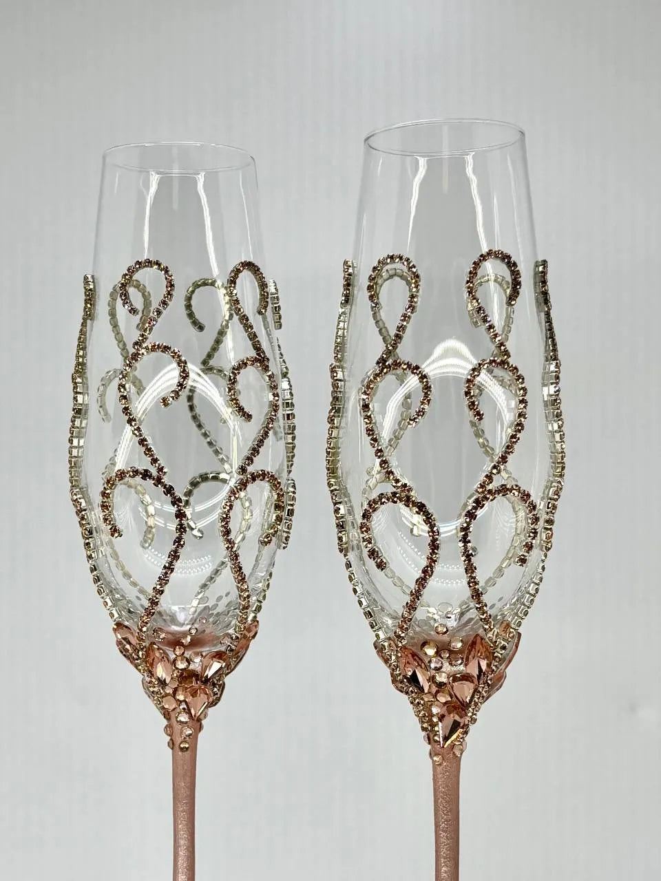 Toasting glasses  with rose gold crystals and engraving for timeless wedding memories.