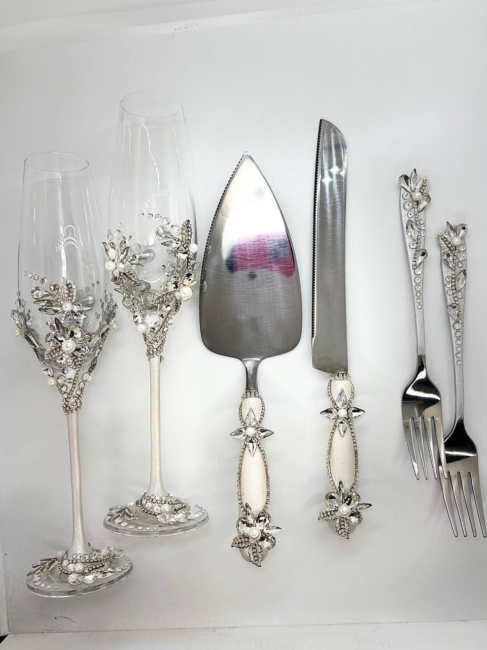 Silver-tone champagne flutes, cake cutting set and forks with shimmering crystal embellishments 