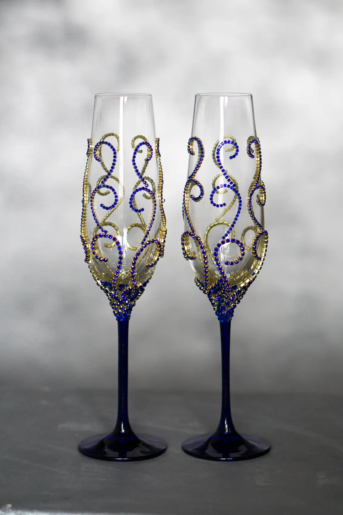 Personalized wedding toasting flutes in gold and royal blue hues