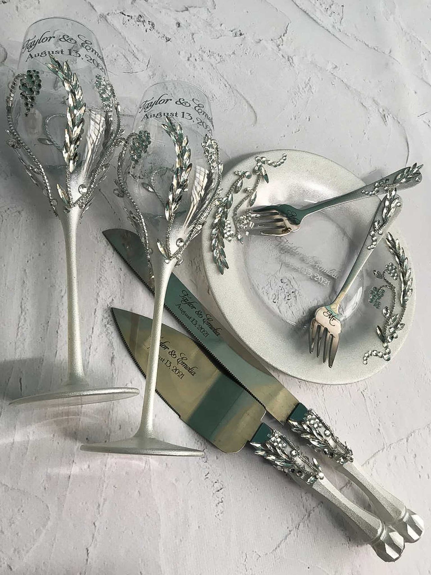 Wedding gift set featuring champagne glasses, cake servers, and a dessert plate