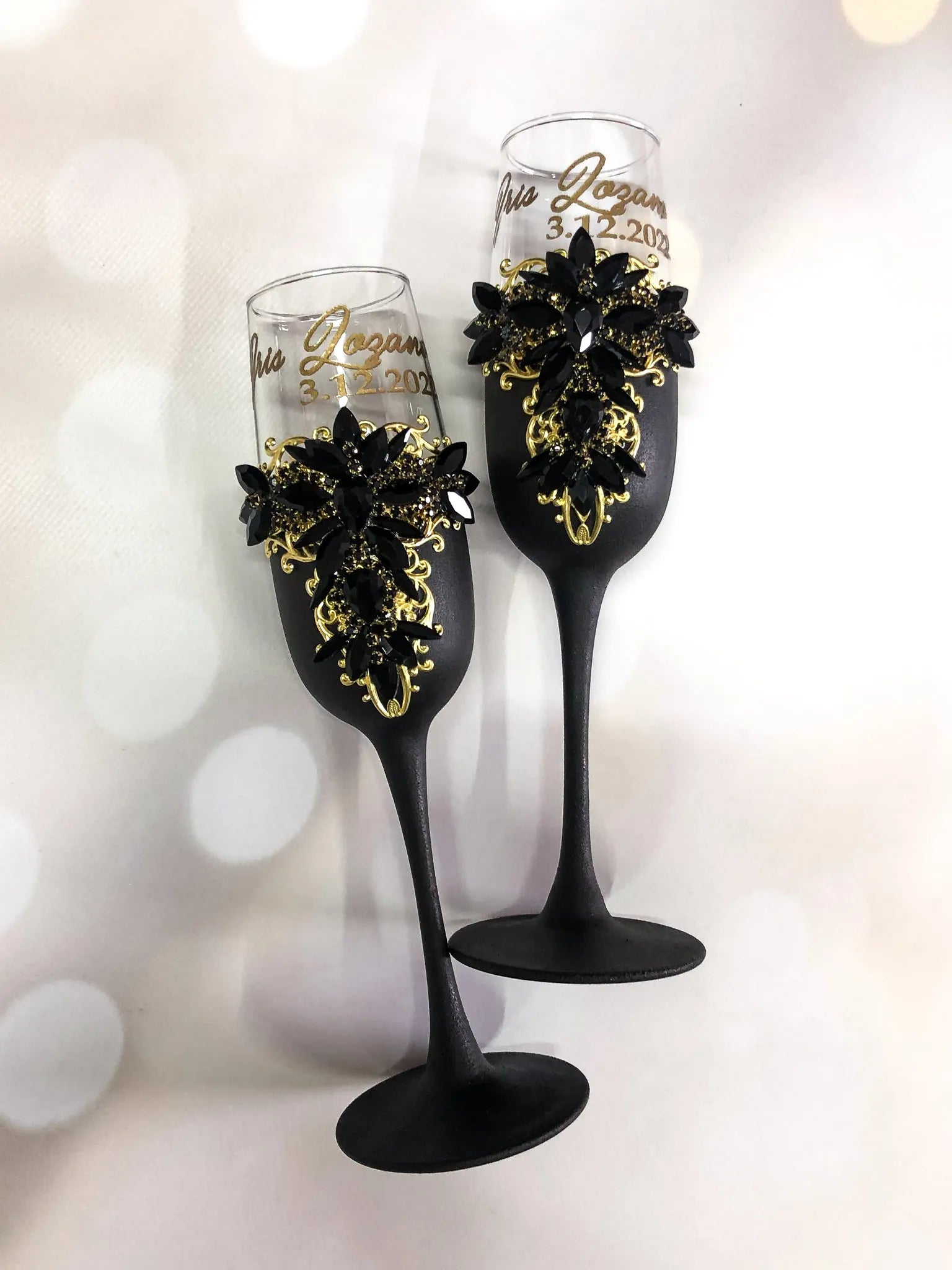 Elegant matte black champagne flutes with gold accents