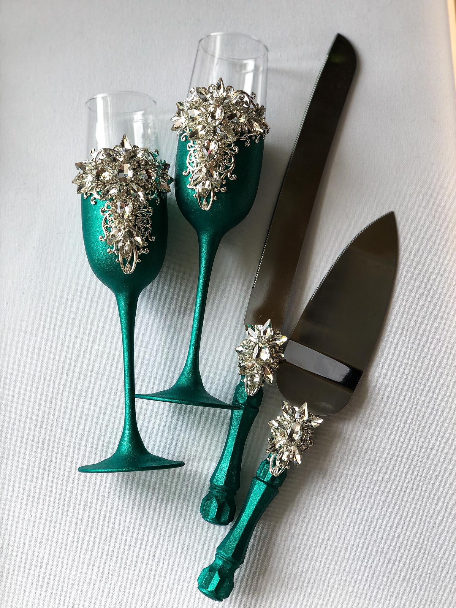 Silver filigree champagne flutes with emerald accents