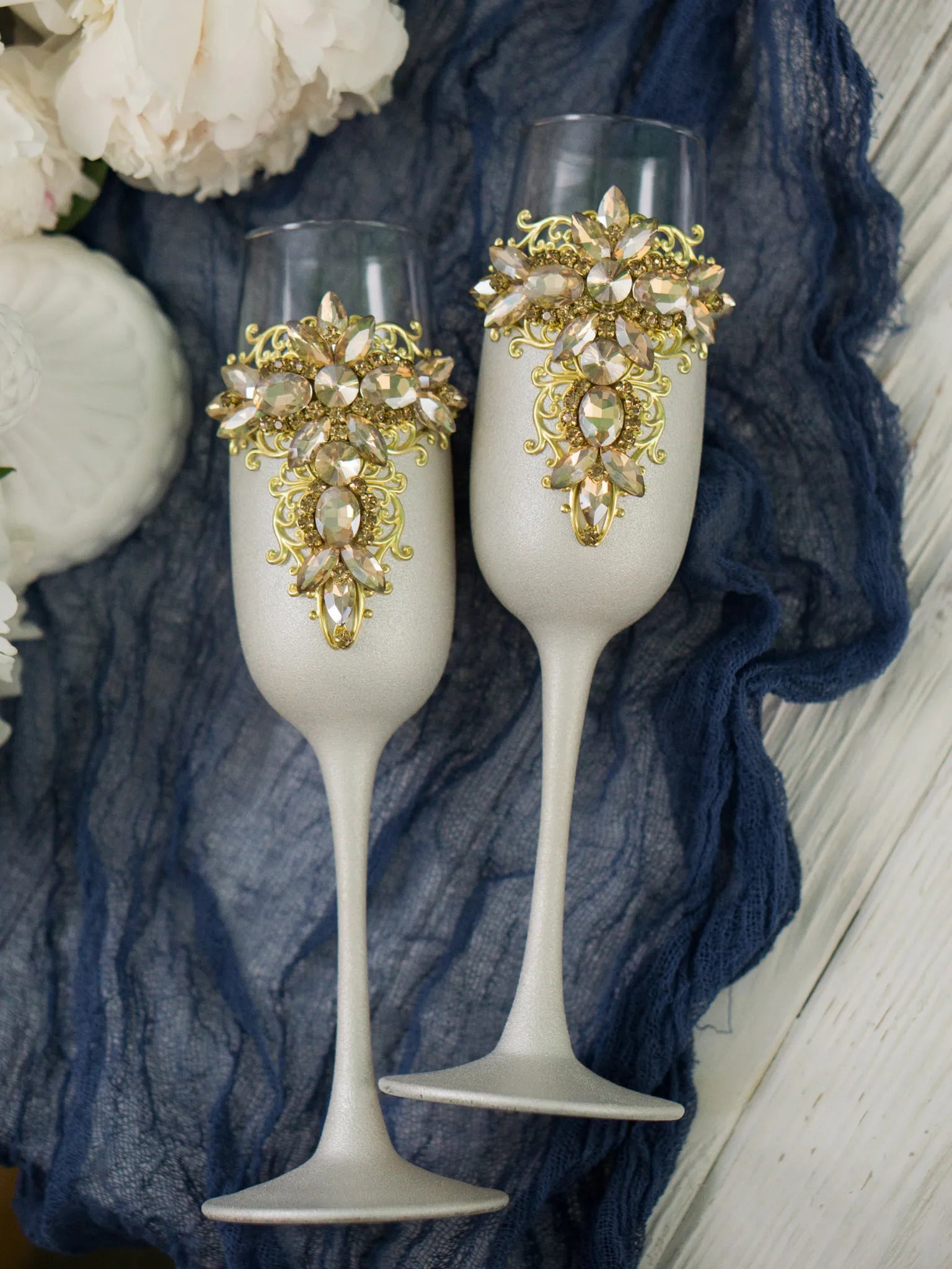 Special occasion champagne glasses with intricate gold decor
