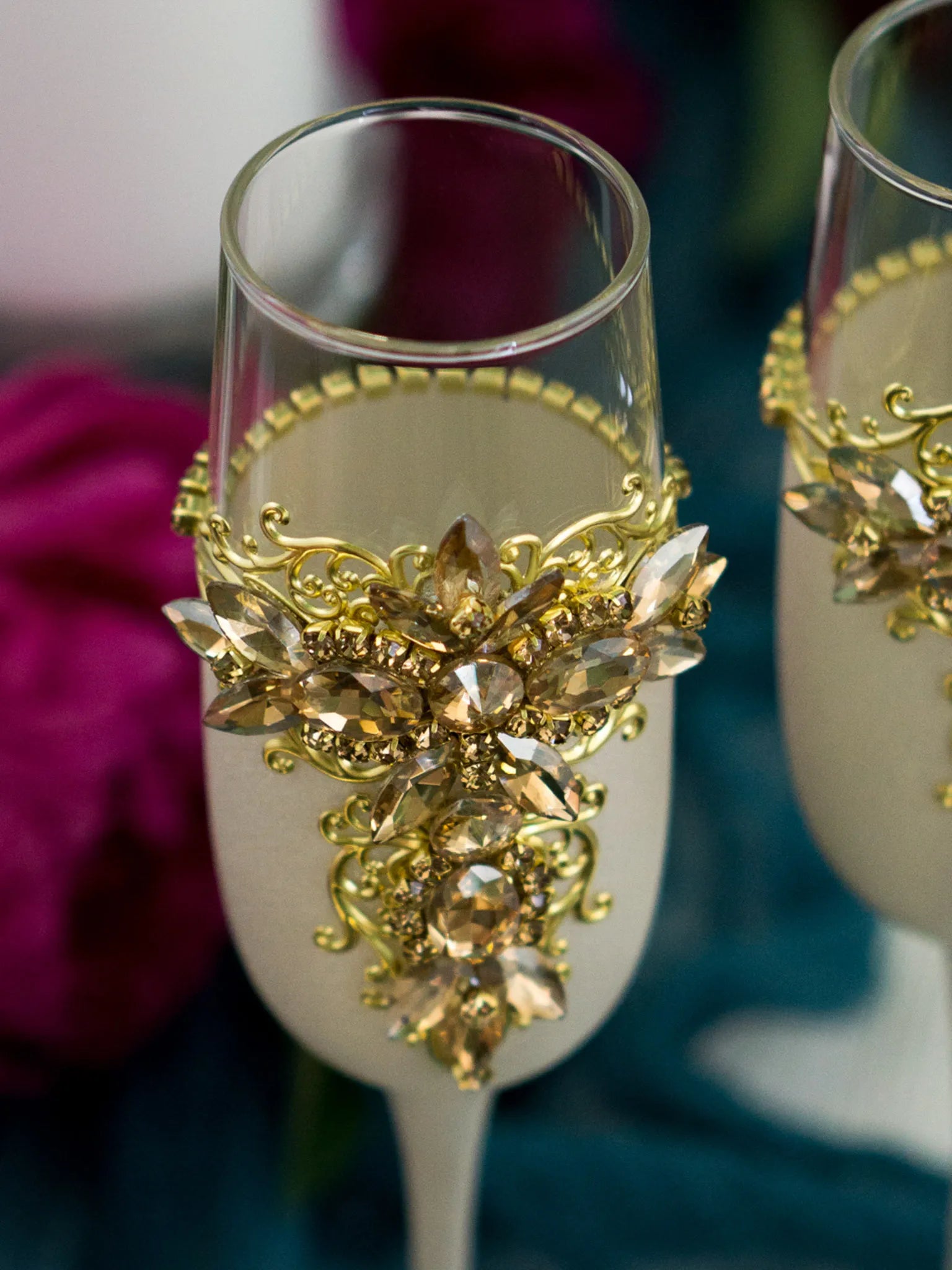 Engraved gold and white wedding flutes with glistening stones