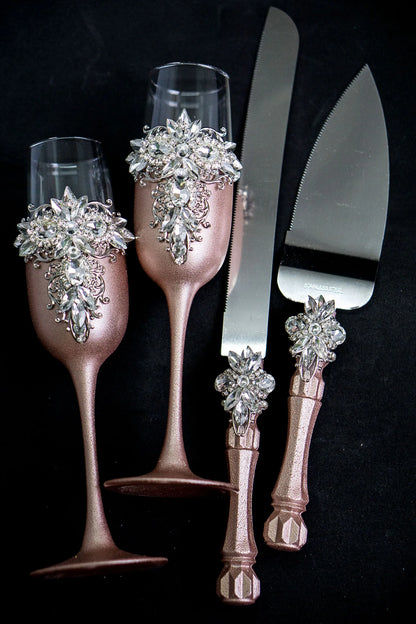 Elegant Rose Gold Crystal Toasting Flutes and Cake Knife Set on display