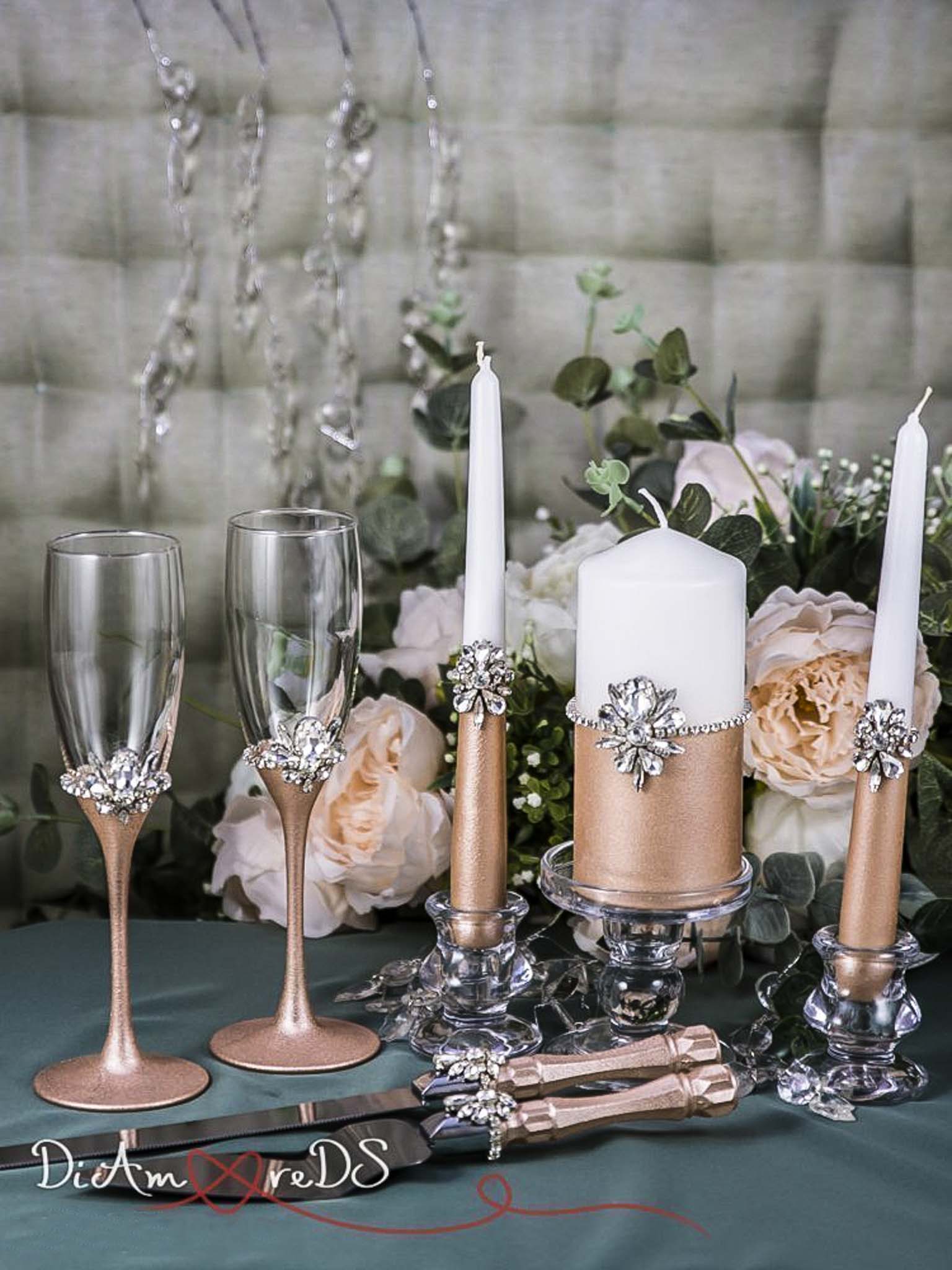 Rose gold wedding champagne flutes and candles