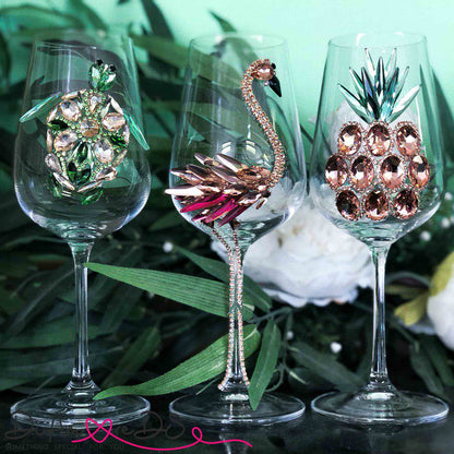 Collection of elegant glassware, each with a unique animal motif crafted from colorful crystals, arranged on a festive table.