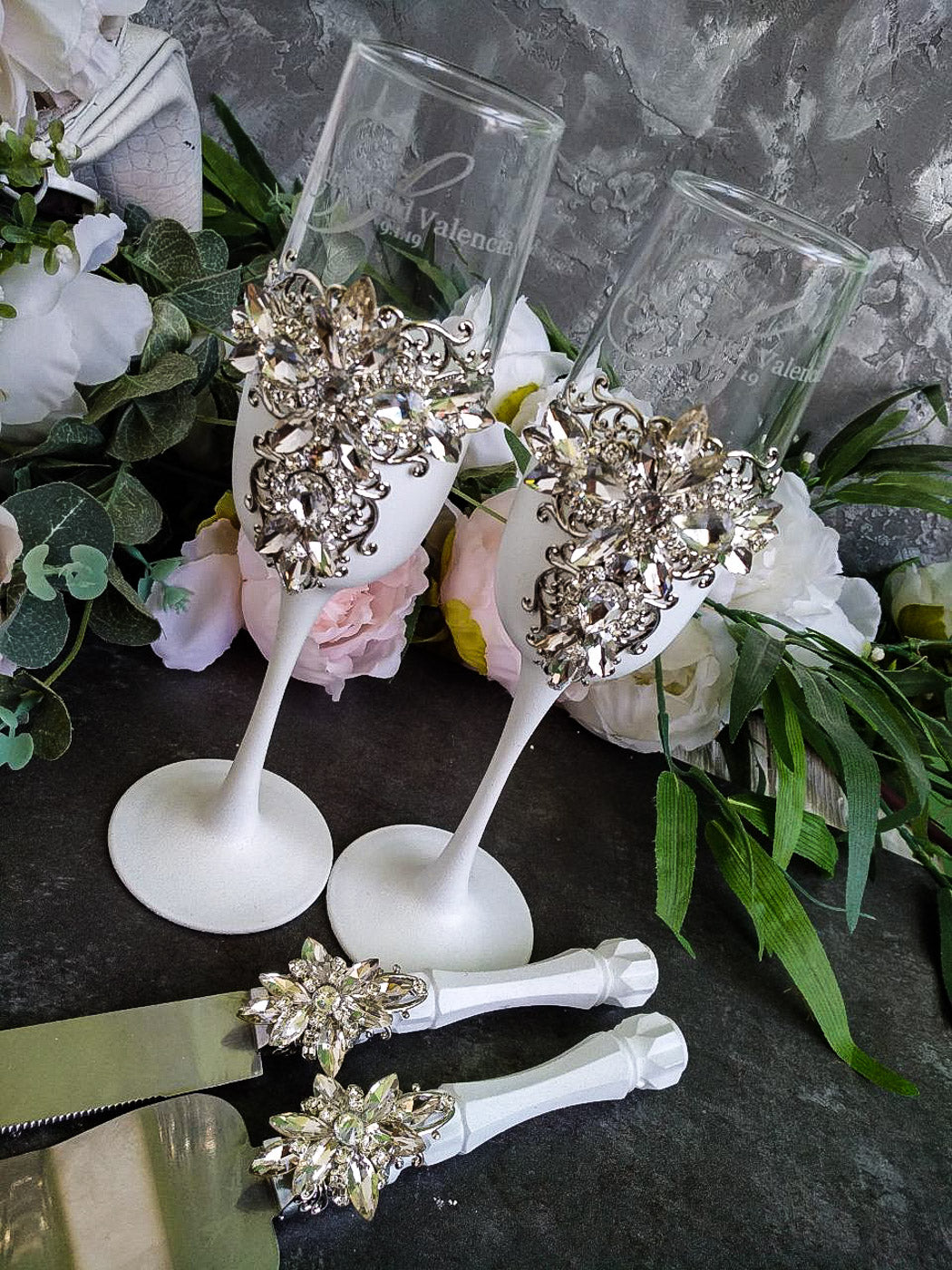 White and Silver Wedding Toast Glasses and Cake Serving Set on display