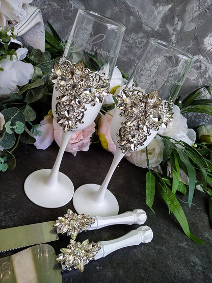 White and Silver Wedding Toast Glasses and Cake Serving Set on display