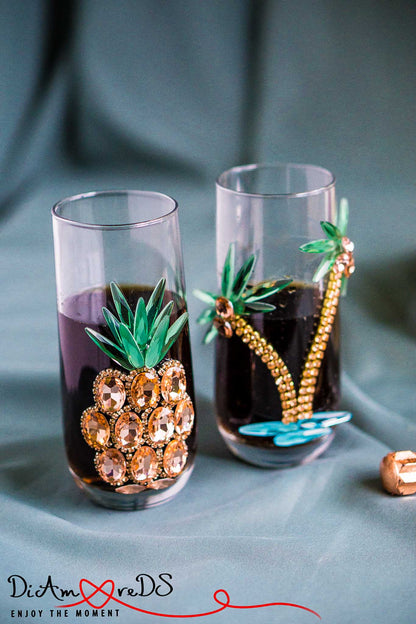 Stylish rose gold pineapple adorning a crystal wine glass for a touch of tropical elegance.