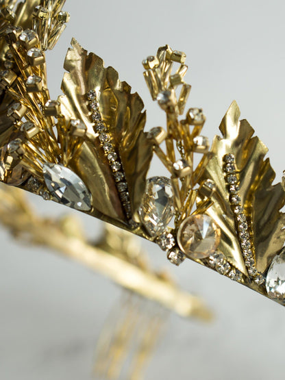 Close-up view of Gold Wedding Crown with Leaves and Crystals on white background