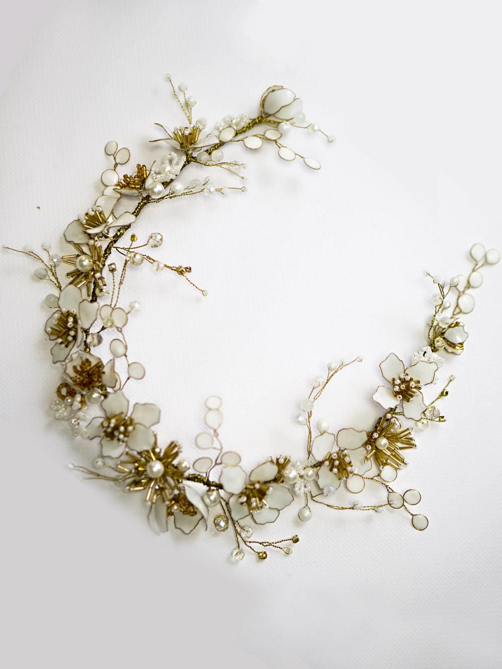 Close-up of a lush white flower hair vine with gold accents, perfect for bridal hair accessories